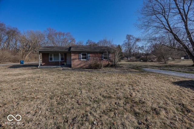 view of front of property with brick siding and a front yard