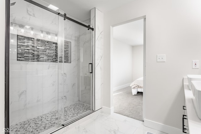 ensuite bathroom with a marble finish shower, marble finish floor, connected bathroom, and baseboards