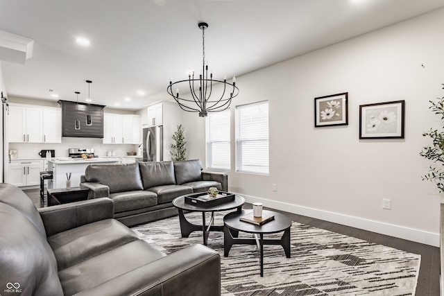 living room with recessed lighting, baseboards, a chandelier, and dark wood finished floors