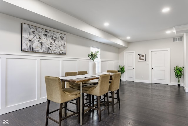 dining area with visible vents, recessed lighting, a decorative wall, and dark wood-style flooring