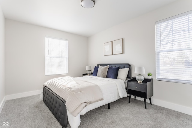 bedroom featuring baseboards and carpet