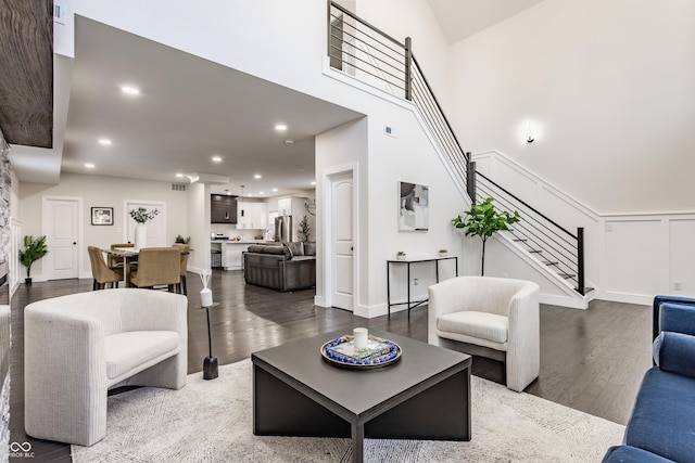 living area with recessed lighting, stairway, visible vents, and wood finished floors