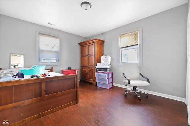 bedroom with visible vents, dark wood-type flooring, and baseboards