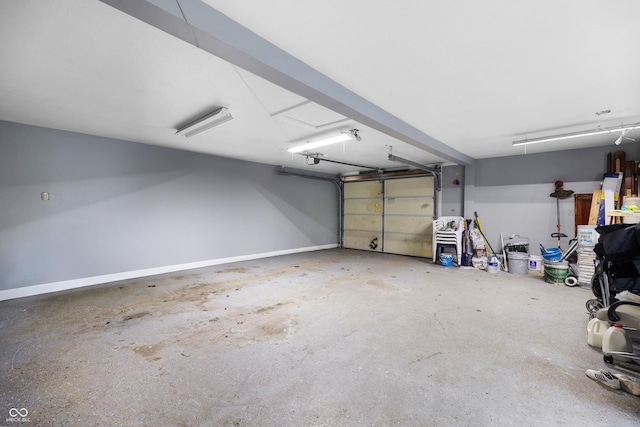 garage featuring a garage door opener and baseboards