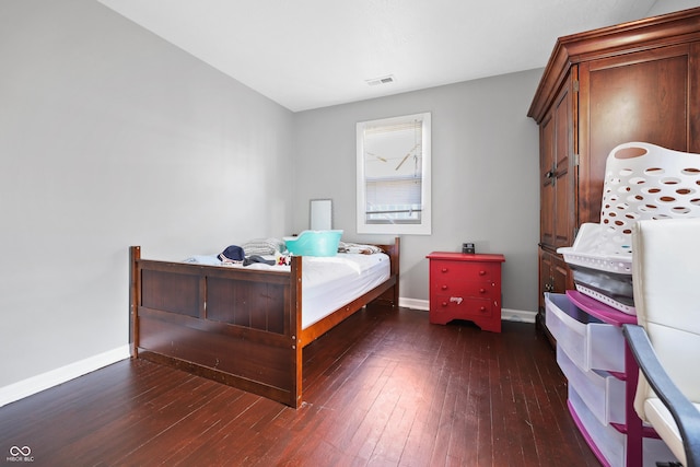 bedroom with visible vents, baseboards, and hardwood / wood-style floors