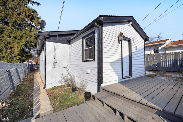 exterior space with a wooden deck and a fenced backyard