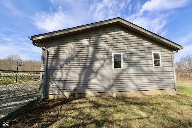 view of side of property with a yard and fence