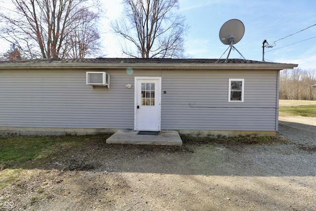 back of property with a wall mounted air conditioner