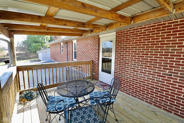 wooden terrace with outdoor dining area