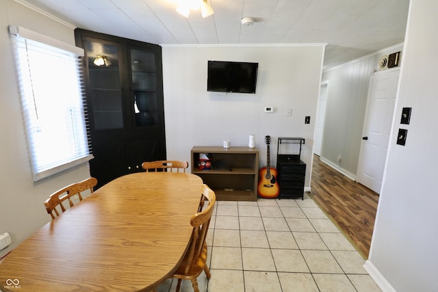 dining room with light tile patterned flooring and ornamental molding