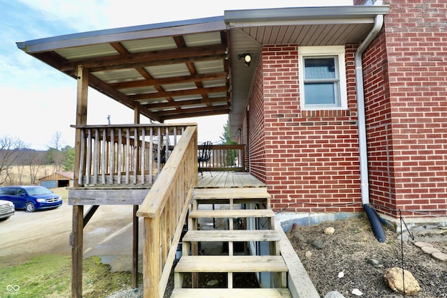 view of exterior entry featuring brick siding