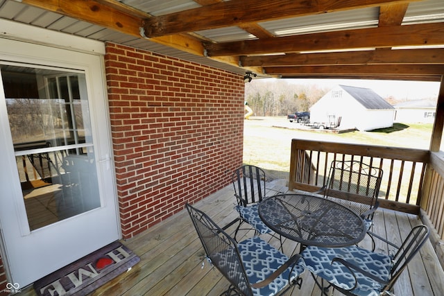 wooden terrace featuring outdoor dining space