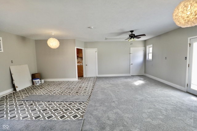 unfurnished living room with baseboards, a ceiling fan, and carpet flooring