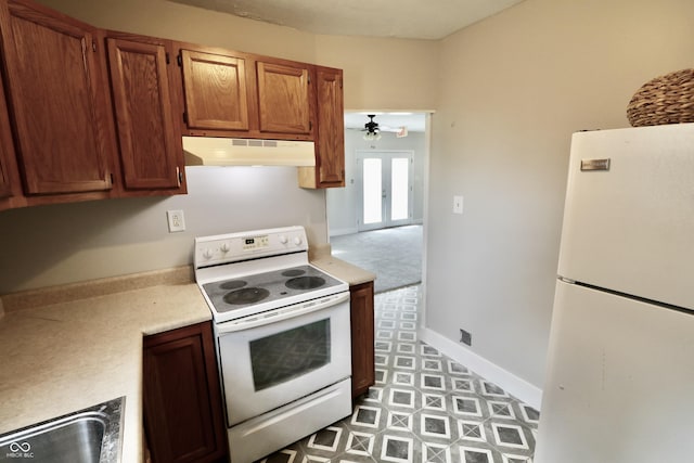 kitchen with white appliances, a ceiling fan, light countertops, under cabinet range hood, and tile patterned floors