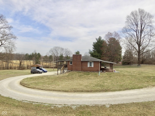 view of home's exterior with driveway, a chimney, and a yard