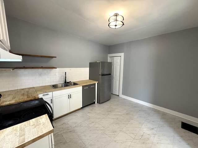 kitchen with a sink, white cabinets, stainless steel appliances, marble finish floor, and open shelves