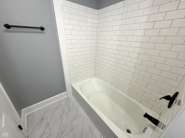 bathroom with shower / tub combination, baseboards, and marble finish floor