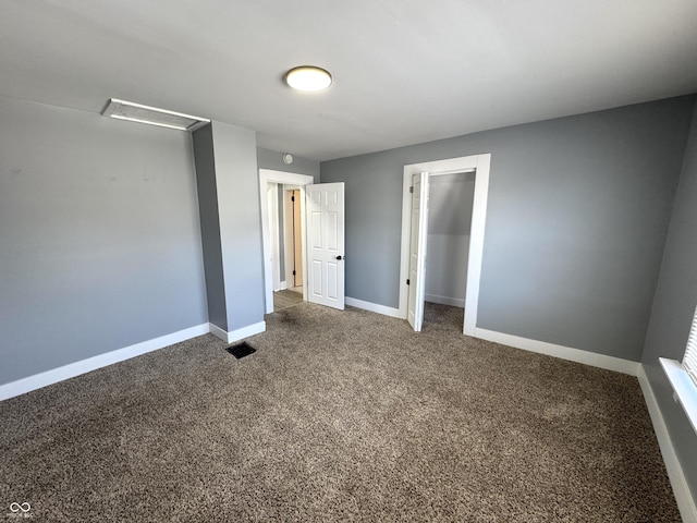 unfurnished bedroom with a closet, baseboards, visible vents, and carpet flooring