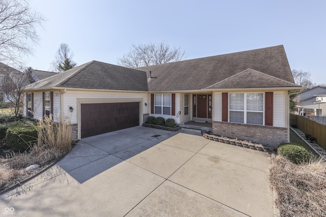 single story home with fence, driveway, a shingled roof, a garage, and brick siding