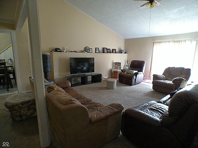 living area featuring a textured ceiling, carpet, a ceiling fan, and vaulted ceiling