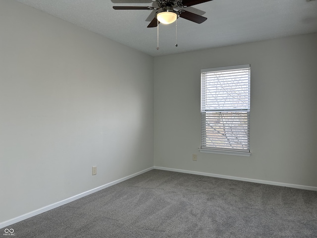 unfurnished room with a ceiling fan, baseboards, and carpet floors