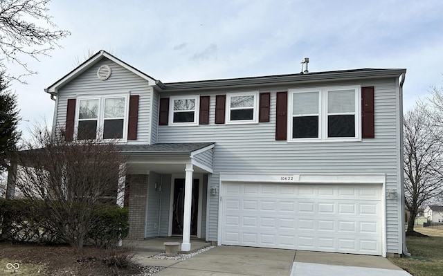 traditional home with an attached garage and driveway