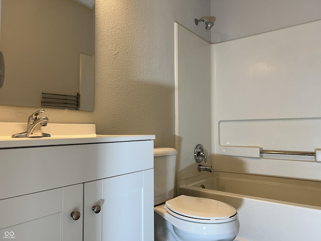 bathroom featuring vanity,  shower combination, toilet, and a textured wall