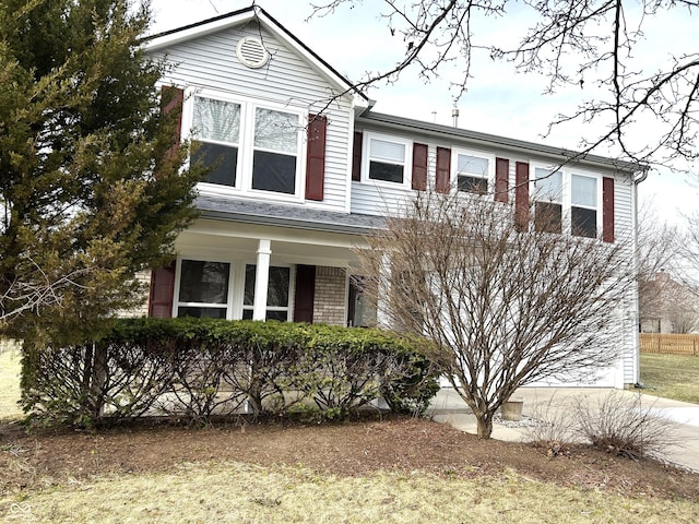 traditional home with brick siding, driveway, and a garage