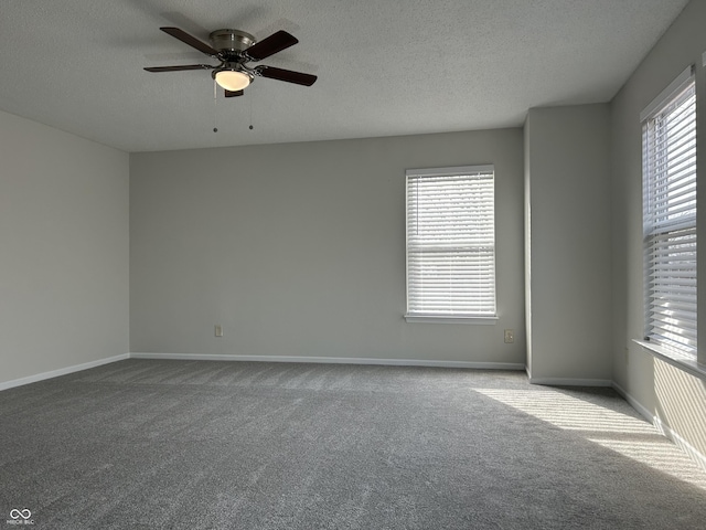 carpeted empty room featuring baseboards, a textured ceiling, and ceiling fan