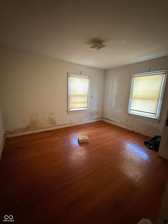 unfurnished room with wood finished floors