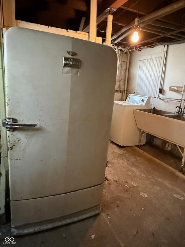 basement featuring a sink and separate washer and dryer