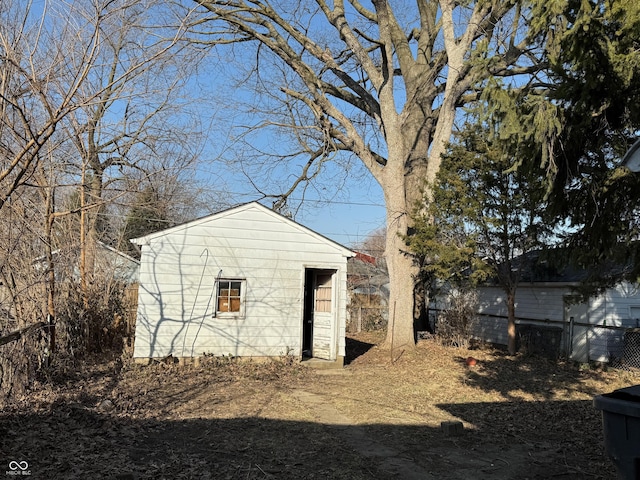 view of outdoor structure with an outbuilding and fence