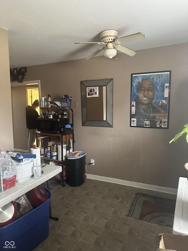 office area with baseboards and ceiling fan