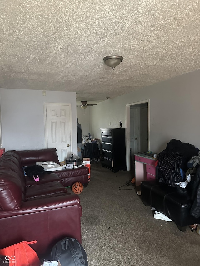 living room with a ceiling fan, carpet floors, and a textured ceiling