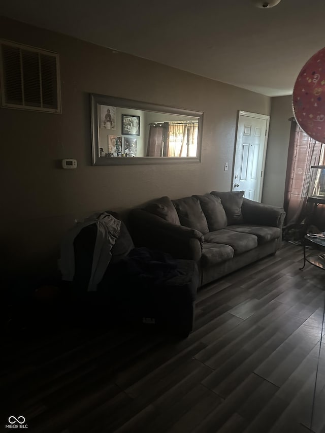 living room featuring visible vents and wood finished floors