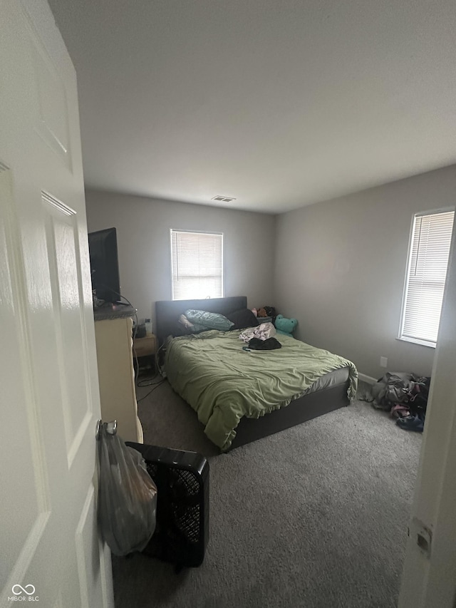 carpeted bedroom with visible vents