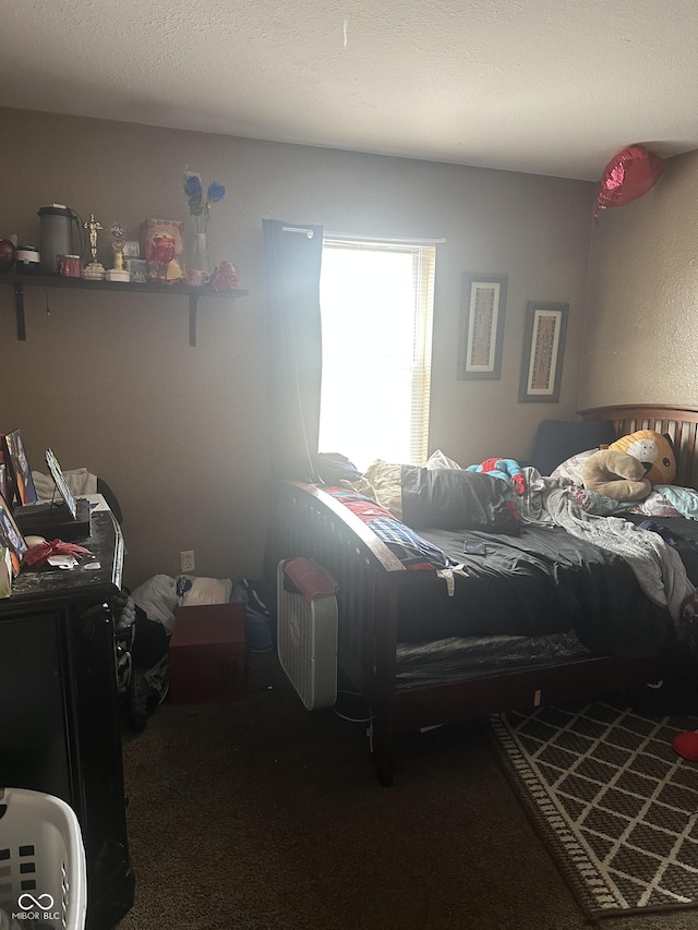 carpeted bedroom with a textured ceiling