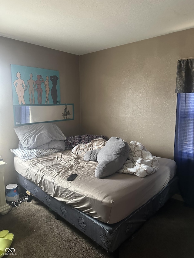 bedroom with carpet flooring and a textured wall