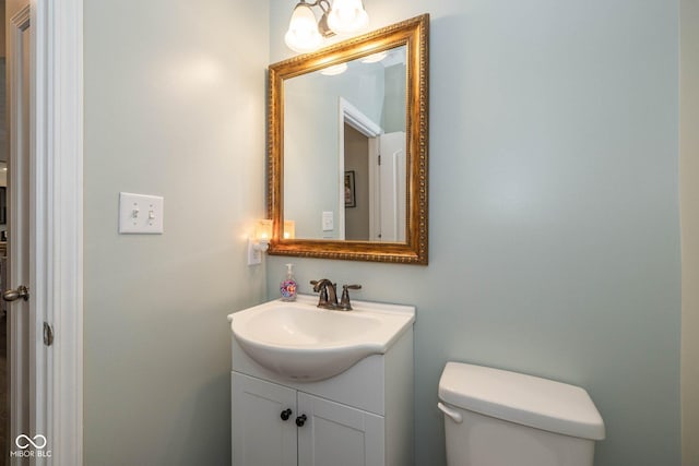 half bathroom with toilet and vanity