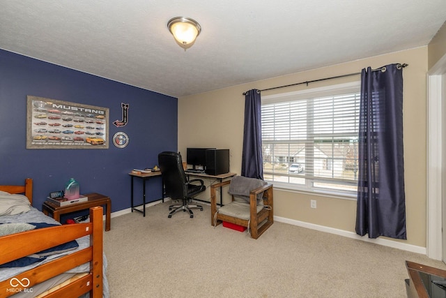 bedroom featuring carpet, baseboards, and a textured ceiling