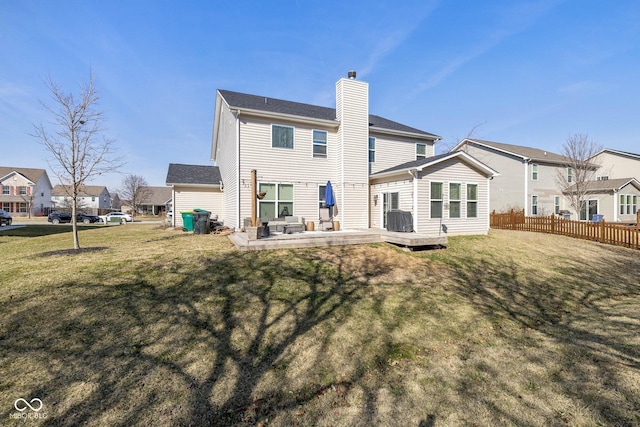 back of house with fence, a yard, cooling unit, a wooden deck, and a chimney