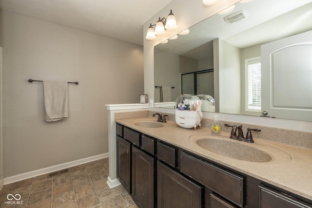 bathroom with a sink, visible vents, and baseboards