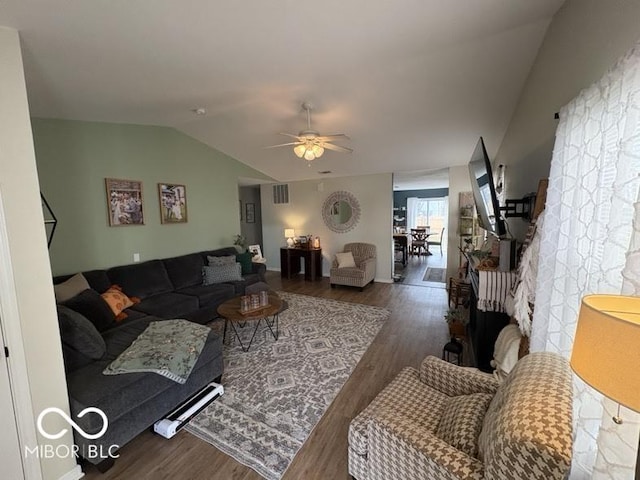 living room with vaulted ceiling, visible vents, ceiling fan, and wood finished floors