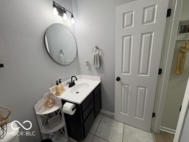 bathroom featuring tile patterned floors, baseboards, and vanity