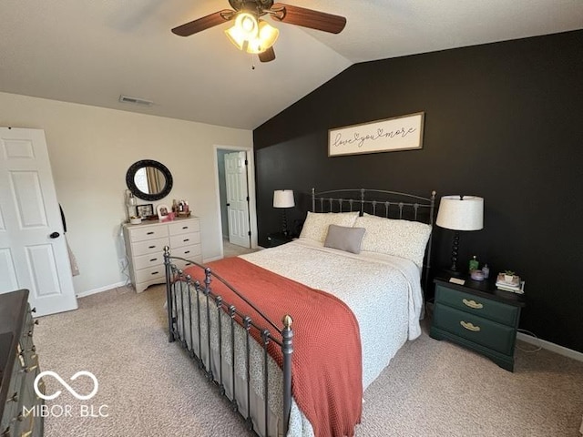 bedroom featuring visible vents, light carpet, a ceiling fan, baseboards, and vaulted ceiling