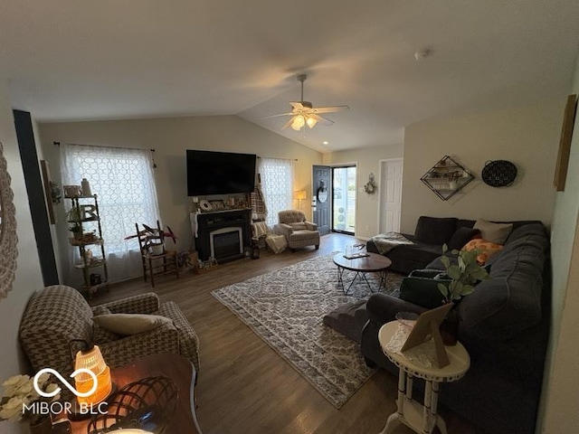 living room featuring plenty of natural light, wood finished floors, a ceiling fan, and vaulted ceiling