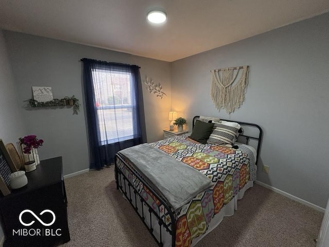 bedroom featuring baseboards and carpet