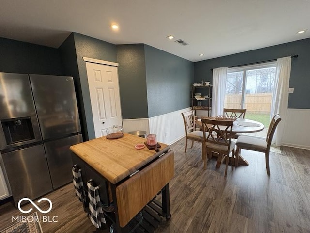 dining space with recessed lighting, a wainscoted wall, dark wood-type flooring, and visible vents