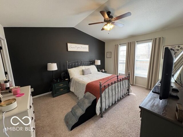 bedroom with baseboards, lofted ceiling, light colored carpet, and ceiling fan