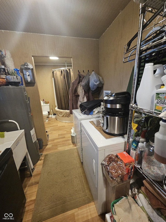 laundry area with light wood-style flooring, wood ceiling, and separate washer and dryer